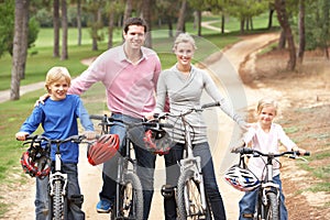 Family enjoying bike ride in park