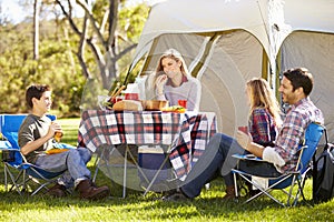 Family Enjoying Camping Holiday In Countryside