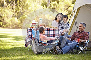 Family Enjoying Camping Holiday In Countryside