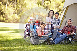 Family Enjoying Camping Holiday In Countryside