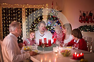 Family enjoying Christmas dinner at home