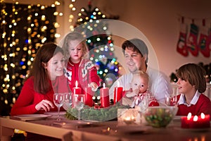 Family enjoying Christmas dinner at home