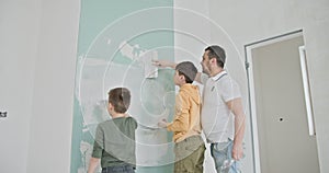 Family Enjoying DIY Home Renovation and Wall Painting Together