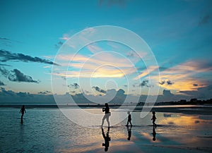 A family enjoying a dramatic blue sunset