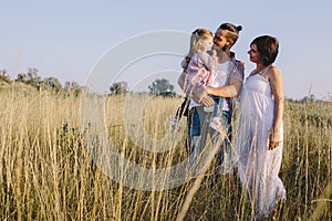 Family enjoying life outdoors in field