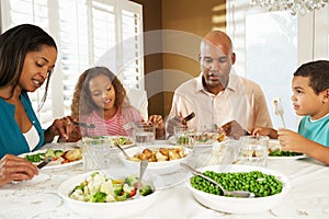 Family Enjoying Meal At Home