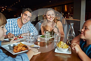 Family Enjoying Meal In Restaurant