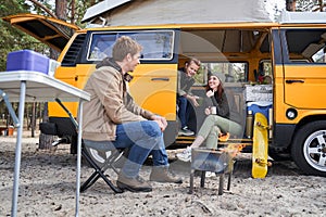 Family enjoying picnic near campfire