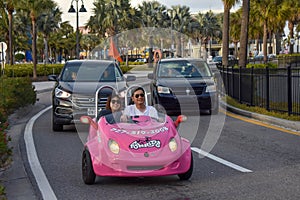 Family enjoying pink scoot coupe close to Piere 60 area in Gulf Coast Beaches 2