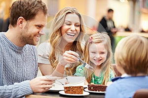 Family Enjoying Snack In Cafe Together