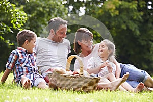 Family Enjoying Summer Picnic In Countryside