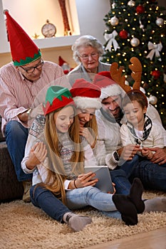 Family enjoying their holiday time together using tablet