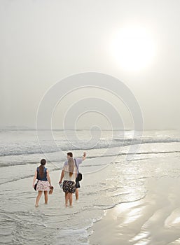 Family enjoying time together on beautiful foggy beach.