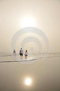 Family enjoying time together on beautiful foggy beach.