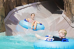 Family enjoying a wet ride down a water slide