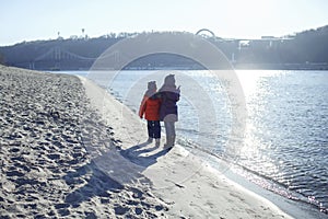 Family enjoying winter together, kids walking on the beach in winter, outdoors lifestyle