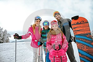 Family enjoying winter vacations in mountains. Ski, Sun, Snow an