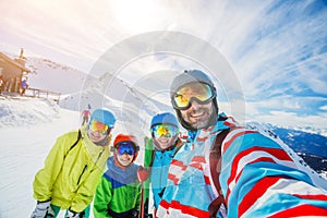 Family enjoying winter vacations in mountains . Ski, Sun, Snow and fun.