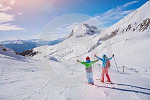 Family enjoying winter vacations in mountains . Ski, Sun, Snow and fun.