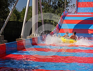 Family enjoys the ride down together at aquapark