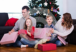 Family exchanging Christmas gifts