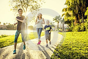 Family exercising and jogging together at the park