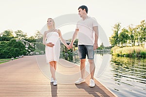 Family expecting a child has a walk on health resort