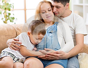 Family expecting new baby. Little boy touching