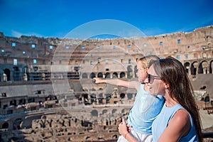 Family exploring Coliseum inside in Rome, Italy. Mother and her daughter portrait at famous places in Europe