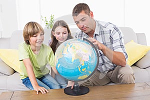 Family exploring globe