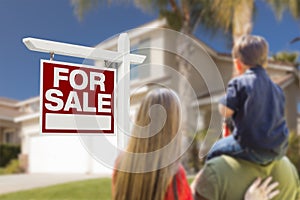 Family Facing For Sale Real Estate Sign and House