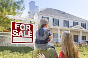 Family Facing For Sale Real Estate Sign and House