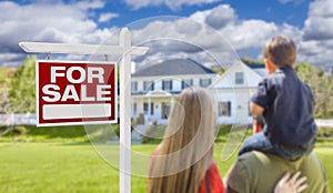 Family Facing For Sale Real Estate Sign and House