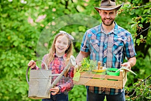Family farm. spring village country. ecology. Watering can and shovel. little girl and happy man dad. earth day. father