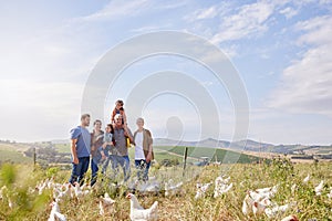 A family farm would be nothing without family. a multi-generational family spending time together on a poultry farm.