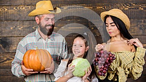 Family farmers with harvest wooden background. Family rustic style farmers market with fall harvest. Parents and