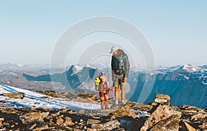 Family father and child climbing mountains together exploring Norway hiking adventure healthy lifestyle outdoor active vacations