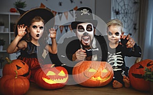 Family father and children in costumes and makeup to halloween w