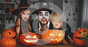 Family father and children in costumes and makeup to halloween w