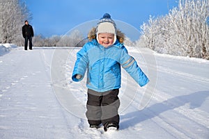 family, father and happy small child the boy on walk in the winter