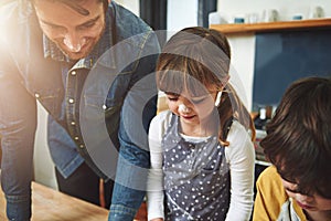 Family, father and kids baking in kitchen, bonding and preparation for lunch in home. Dad, children and cooking together