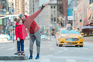 Family of father and little kid on Times Square during their vacation in New York City photo