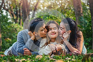 Family, father, mother and daughter having goodtime together in park