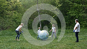 Family: father, mother, son and  daughter  in the Park in medical masks and white t-shirts and rubber gloves .  Everyone is