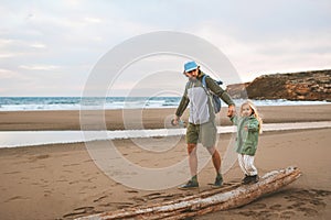 Family father walking with child on the beach summer vacations lifestyle travel together parent dad with daughter