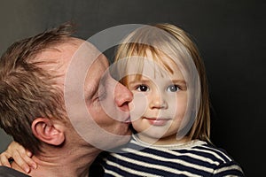 Family, fatherhood and people concept. Happy affectionate father kissing little baby daughter