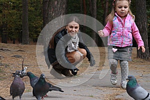 Family feeding pigeons together