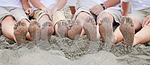 Family feet on beach in line