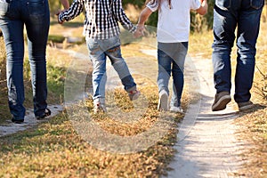 Family feet and legs in jeans.