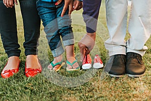 Family feet posing for baby announcement photo